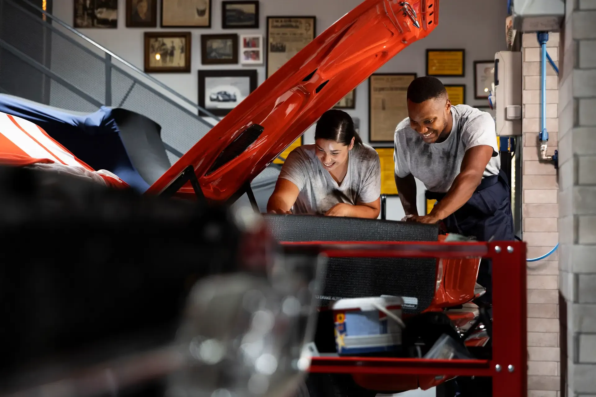 Technicians inspecting a car in an automotive workshop