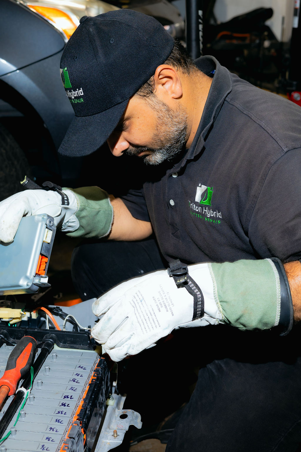 Sal performing module-level hybrid battery testing at Triton Hybrid Battery Repair in Lorton, VA
